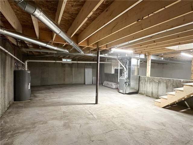 258 Mcmaster St, Bath, NY 14810 - unfinished basement featuring electric water heater, stairs, and heating unit