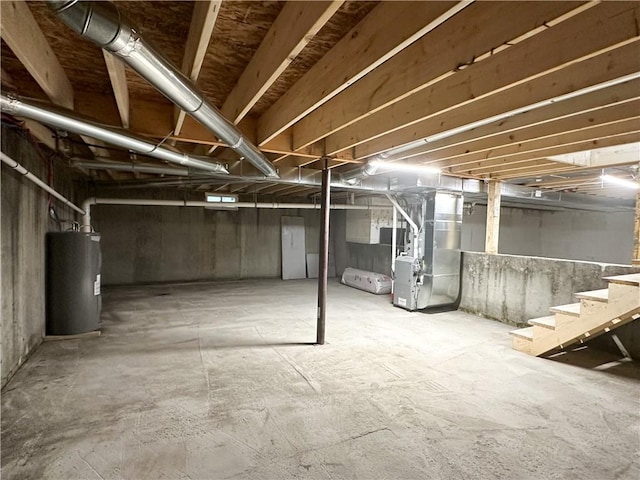 258 Mcmaster St, Bath, NY 14810 - unfinished below grade area featuring electric water heater, stairway, and heating unit
