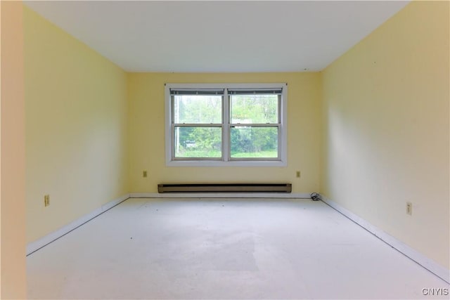 empty room with concrete flooring and a baseboard radiator