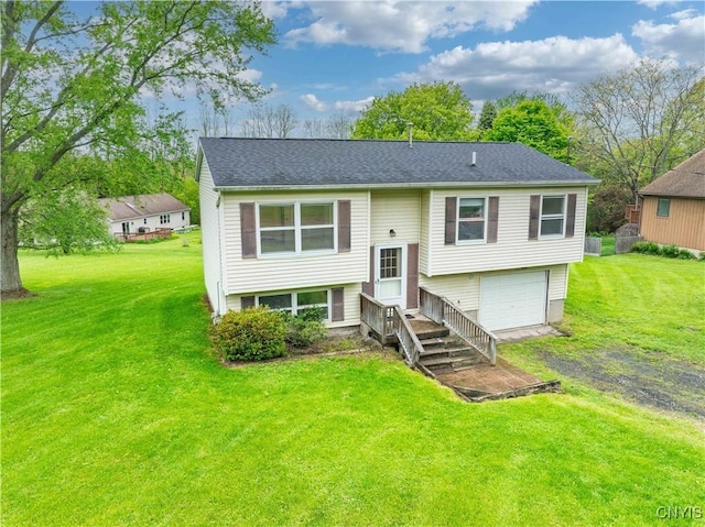 view of front of home with driveway, an attached garage, a front yard, and a shingled roof
