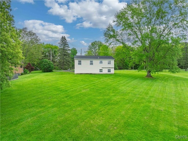 view of grassy yard with view of scattered trees