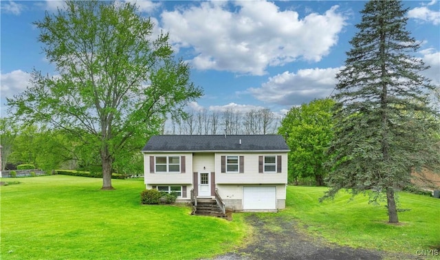 view of front of property with driveway, a garage, and a front yard