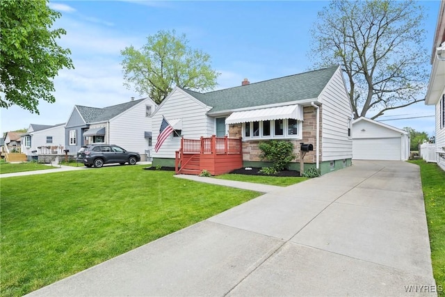 view of front of property featuring a garage, roof with shingles, a front lawn, an outdoor structure, and a residential view