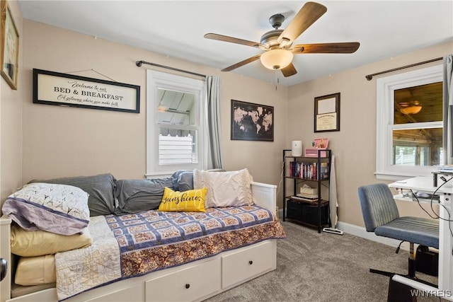 carpeted bedroom with a ceiling fan and baseboards