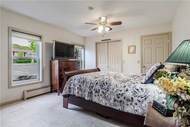 174 Camp Rd, Litchfield, NY 13322 - carpeted bedroom with a baseboard heating unit, a closet, a ceiling fan, and baseboards