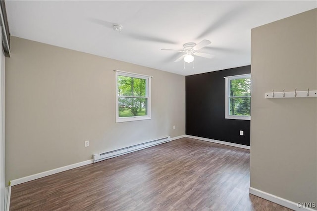 unfurnished room with a baseboard radiator, ceiling fan, wood finished floors, and baseboards