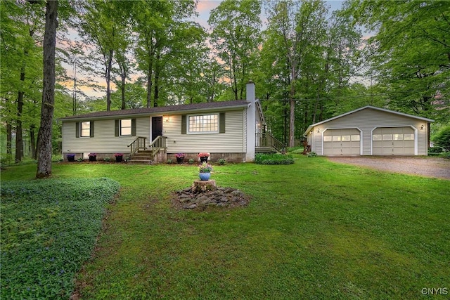 view of front facade with a garage, a chimney, an outdoor structure, a lawn, and view of wooded area