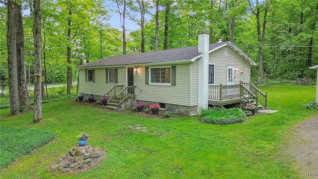 view of front of home featuring a chimney and a front yard