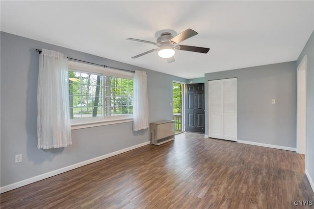 unfurnished bedroom with wood finished floors, baseboards, a closet, and ceiling fan