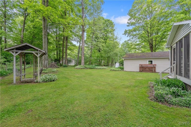 view of green lawn with a sunroom