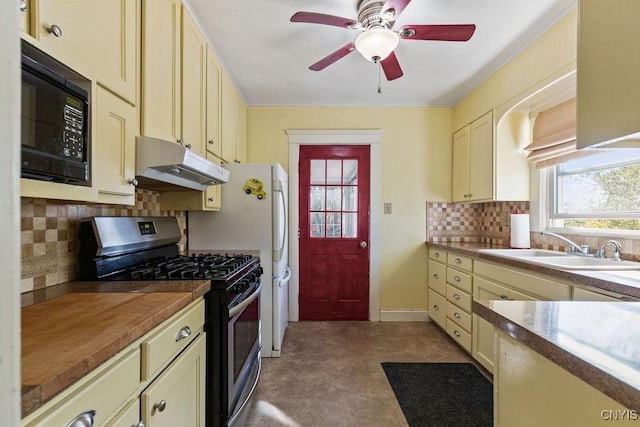 kitchen with under cabinet range hood, stainless steel gas stove, black microwave, a sink, and backsplash