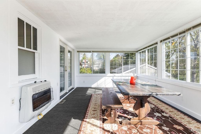 sunroom with heating unit, healthy amount of natural light, and baseboards