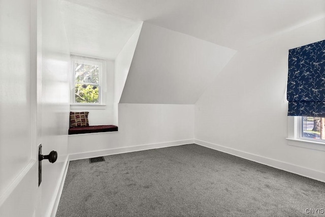 bonus room with healthy amount of natural light, carpet floors, vaulted ceiling, and baseboards
