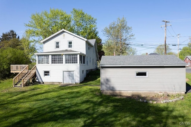rear view of house with stairs, a sunroom, a lawn, and a wooden deck