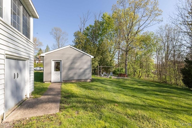 view of green lawn featuring an outbuilding