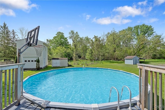 outdoor pool with a storage unit, an outbuilding, and a lawn
