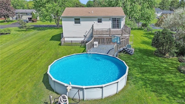 back of property featuring a wooden deck and a lawn