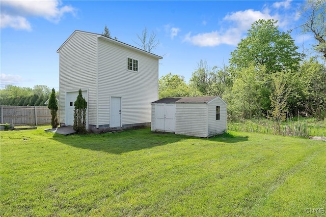 rear view of house featuring a storage shed and an outbuilding