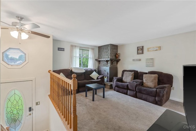 carpeted living room with a ceiling fan