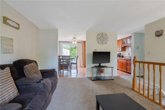 living room with light carpet and ceiling fan