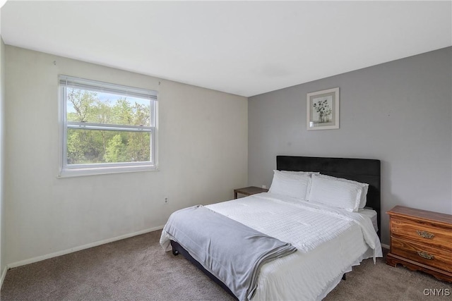 bedroom featuring carpet floors and baseboards