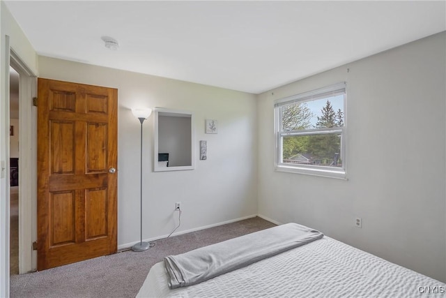 bedroom featuring carpet flooring and baseboards