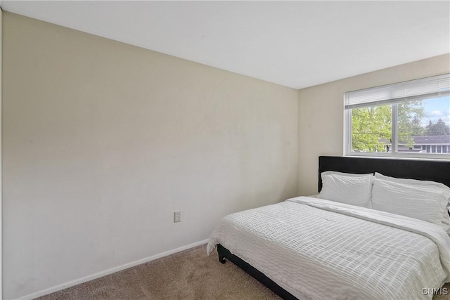 bedroom featuring carpet flooring and baseboards