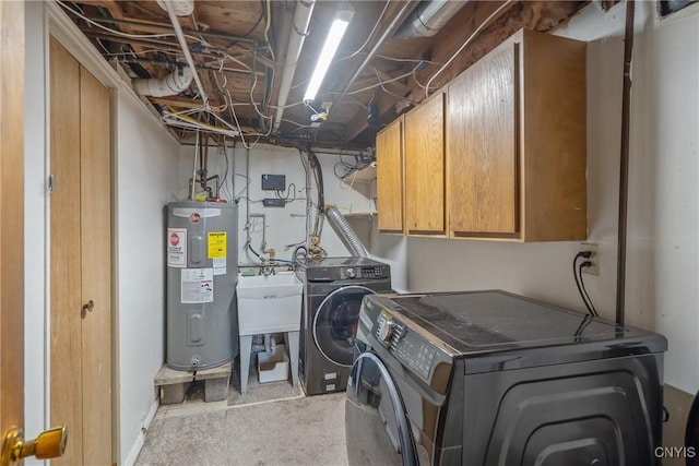 laundry room with electric water heater, washing machine and clothes dryer, cabinet space, and light colored carpet