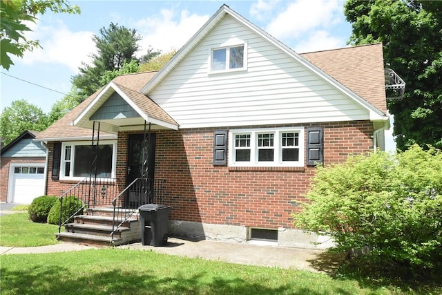 806 Mount Zoar St, Southport, NY 14904 - view of front of property with brick siding, an attached garage, a shingled roof, and a front lawn