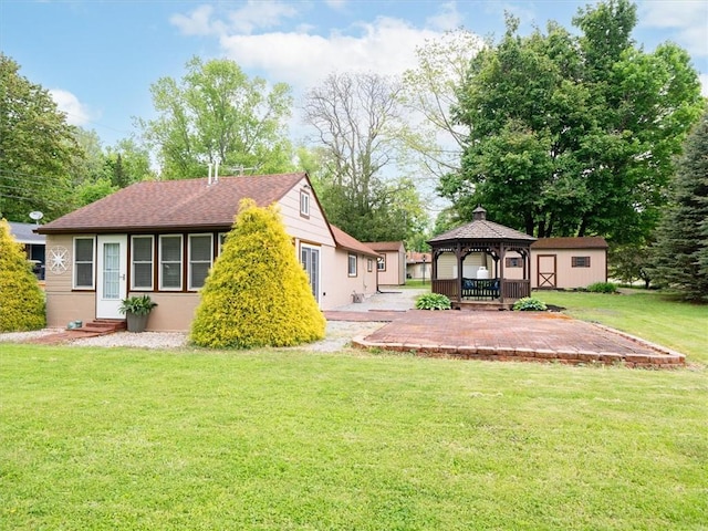 8521 W Buckingham St, Richmond, NY 14471 - rear view of house featuring a gazebo, a patio area, entry steps, and a lawn