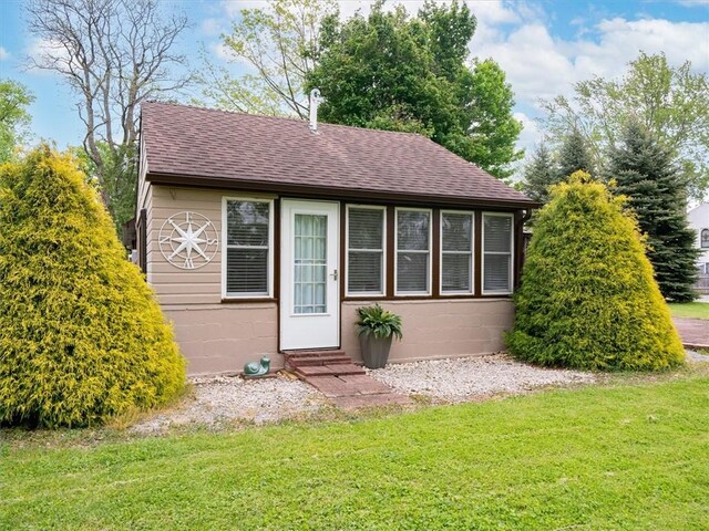 8521 W Buckingham St, Richmond, NY 14471 - view of front of home featuring entry steps, a shingled roof, a front yard, and concrete block siding