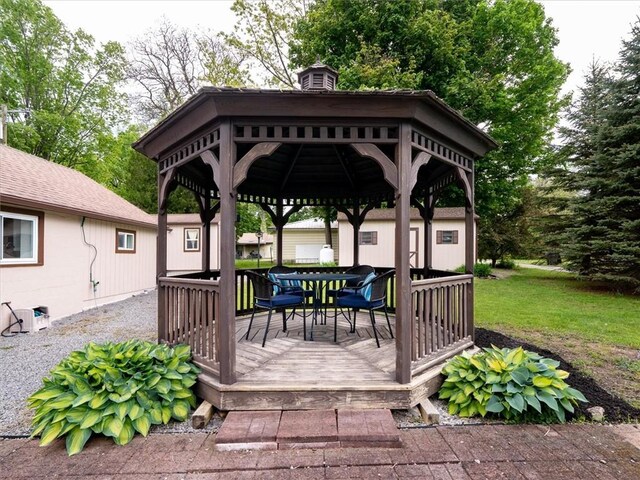 8521 W Buckingham St, Richmond, NY 14471 - deck featuring outdoor dining area, a gazebo, and a lawn