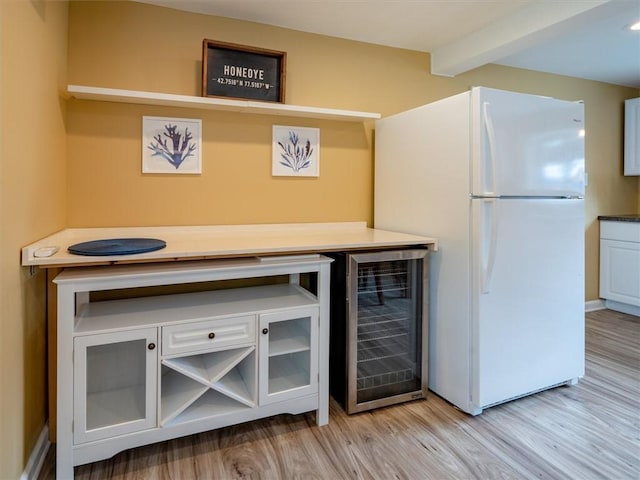 8521 W Buckingham St, Richmond, NY 14471 - detailed view of freestanding refrigerator, wine cooler, light wood finished floors, beam ceiling, and a bar