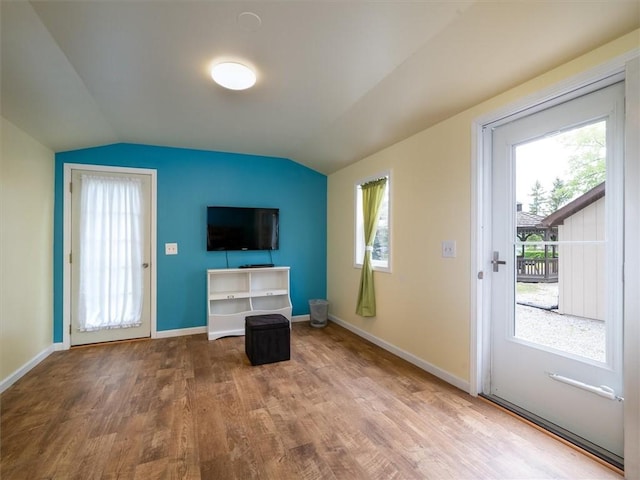 8521 W Buckingham St, Richmond, NY 14471 - unfurnished living room featuring wood finished floors, lofted ceiling, baseboards, and plenty of natural light