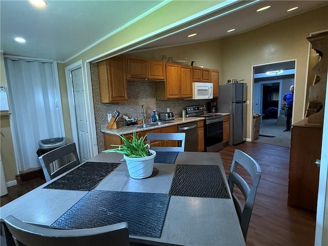760 Spruce St, Southport, NY 14904 - kitchen with appliances with stainless steel finishes, tasteful backsplash, dark wood-style flooring, a sink, and vaulted ceiling