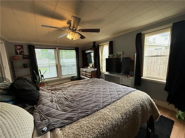 760 Spruce St, Southport, NY 14904 - bedroom with crown molding, wood finished floors, multiple windows, ceiling fan, and baseboards