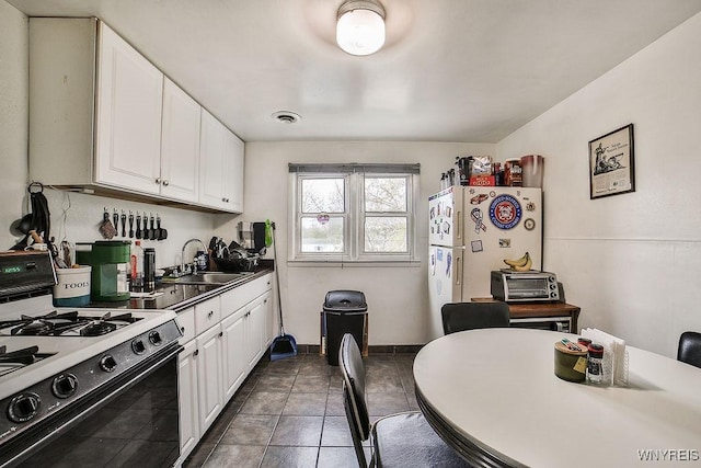 3648 S Park Ave, Hamburg, NY 14219 - kitchen with gas range, a sink, white cabinetry, and tile patterned floors