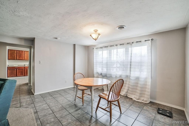 3648 S Park Ave, Hamburg, NY 14219 - tiled dining space with baseboards and a textured ceiling
