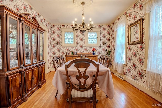 18 Avery Pl, Utica, NY 13502 - dining room with light wood finished floors, a chandelier, wallpapered walls, baseboards, and a baseboard radiator