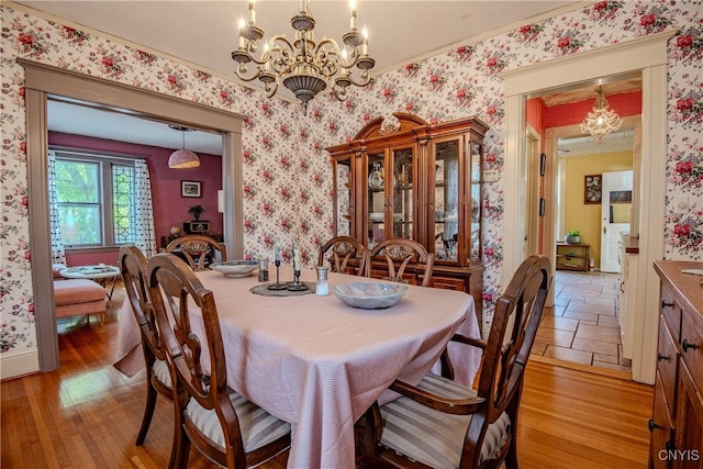 18 Avery Pl, Utica, NY 13502 - dining area featuring a chandelier, wallpapered walls, crown molding, and light wood-type flooring