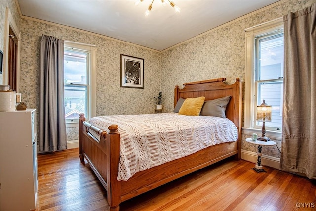 18 Avery Pl, Utica, NY 13502 - bedroom with hardwood / wood-style floors, crown molding, wallpapered walls, and baseboards