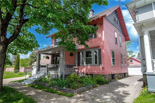 18 Avery Pl, Utica, NY 13502 - view of front of house with a porch, an outbuilding, a garage, and a chimney