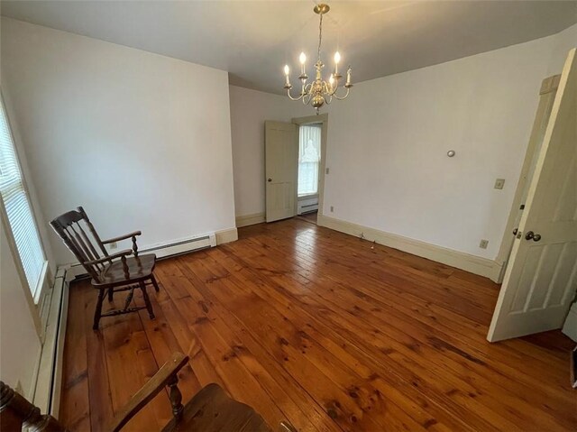 211 Main St, Delhi, NY 13753 - unfurnished room featuring a chandelier, hardwood / wood-style floors, a baseboard heating unit, and baseboards
