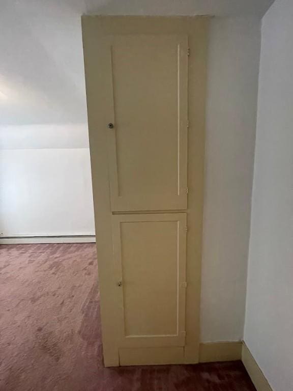 211 Main St, Delhi, NY 13753 - detailed view of carpet, baseboards, and a baseboard heating unit