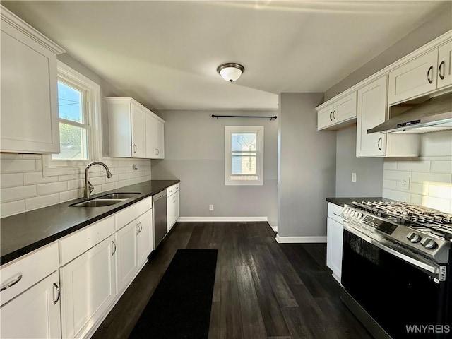101 Spruce St, Lackawanna, NY 14218 - kitchen with appliances with stainless steel finishes, a sink, baseboards, under cabinet range hood, and dark countertops