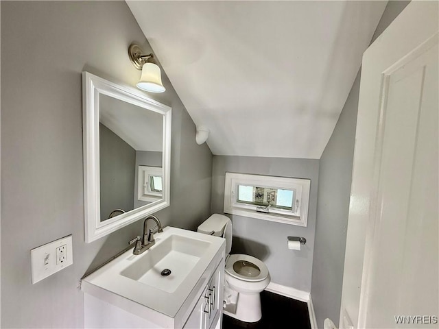 101 Spruce St, Lackawanna, NY 14218 - half bathroom with lofted ceiling, toilet, vanity, and baseboards