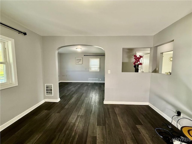 101 Spruce St, Lackawanna, NY 14218 - spare room featuring arched walkways, wood finished floors, and baseboards