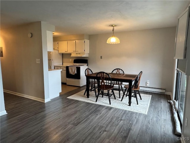 dining room featuring dark wood-style floors, baseboard heating, and baseboards