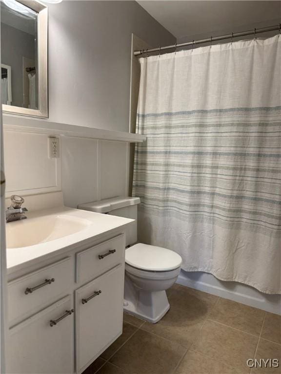 bathroom featuring vanity, tile patterned flooring, toilet, and shower / bathtub combination with curtain