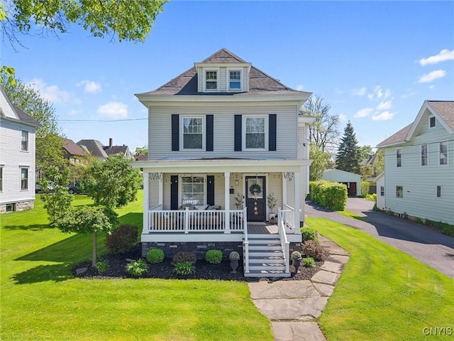 traditional style home featuring a porch, a front lawn, and stairway